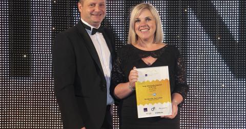 Hazel Davies, sales and marketing director of Cruden Homes collecting award for Large Housing Development of the Year at Scottish Homes Awards