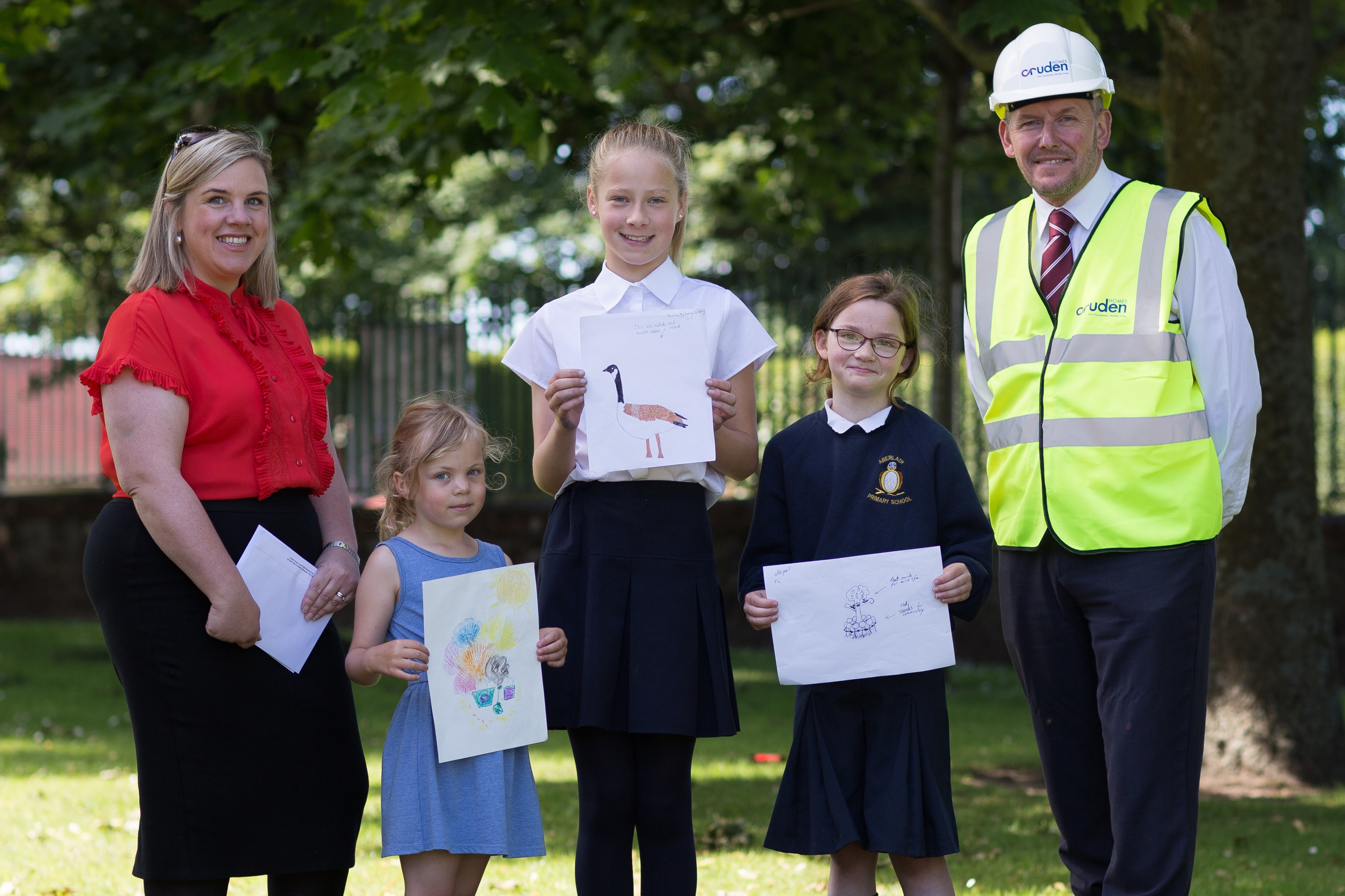 Cruden Homes’ sales and marketing director, Hazel Davies, competition runner-up, Ella, competition winner, Lotte, competition runner-up, Abigail and Cruden Homes’ contracts manager at the Meadowside development, Andy Brown, at the prize giving presentation held recently at Aberlady Primary School.